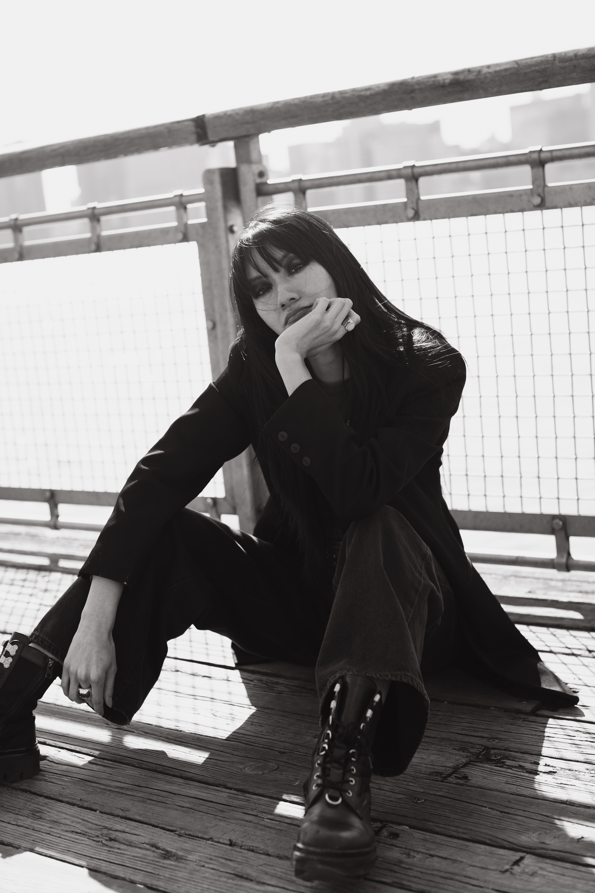 Darin black and white fashion editorial portrait seated waterfront