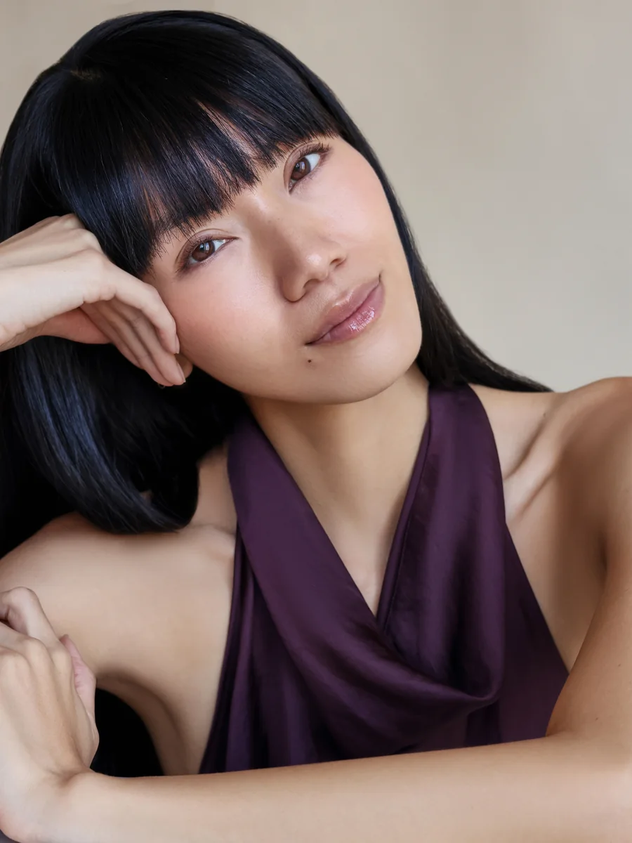 Darin Apinya reclining beauty portrait in a purple halter top