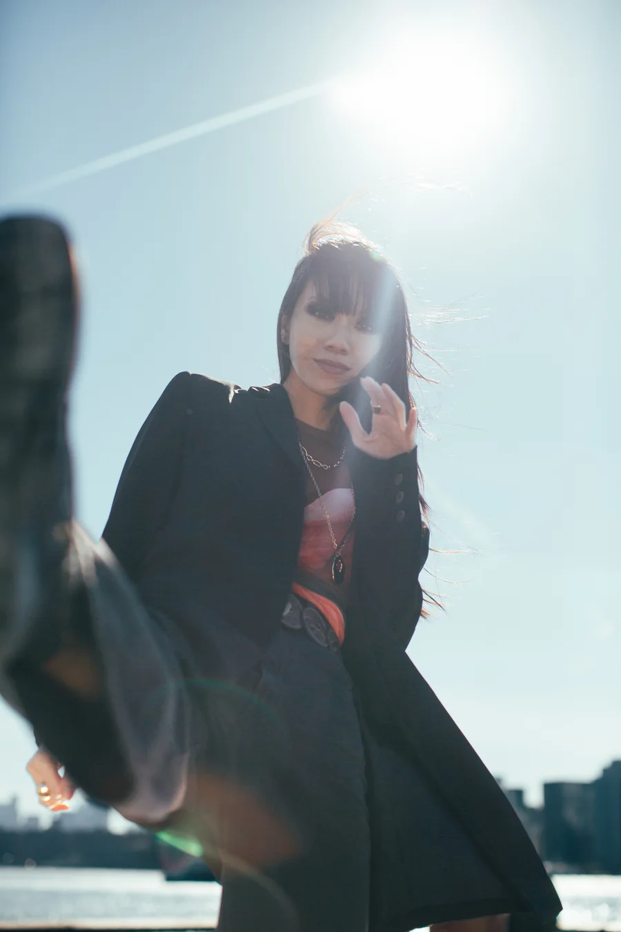 Darin Apinya dynamic fashion editorial kick pose NYC skyline